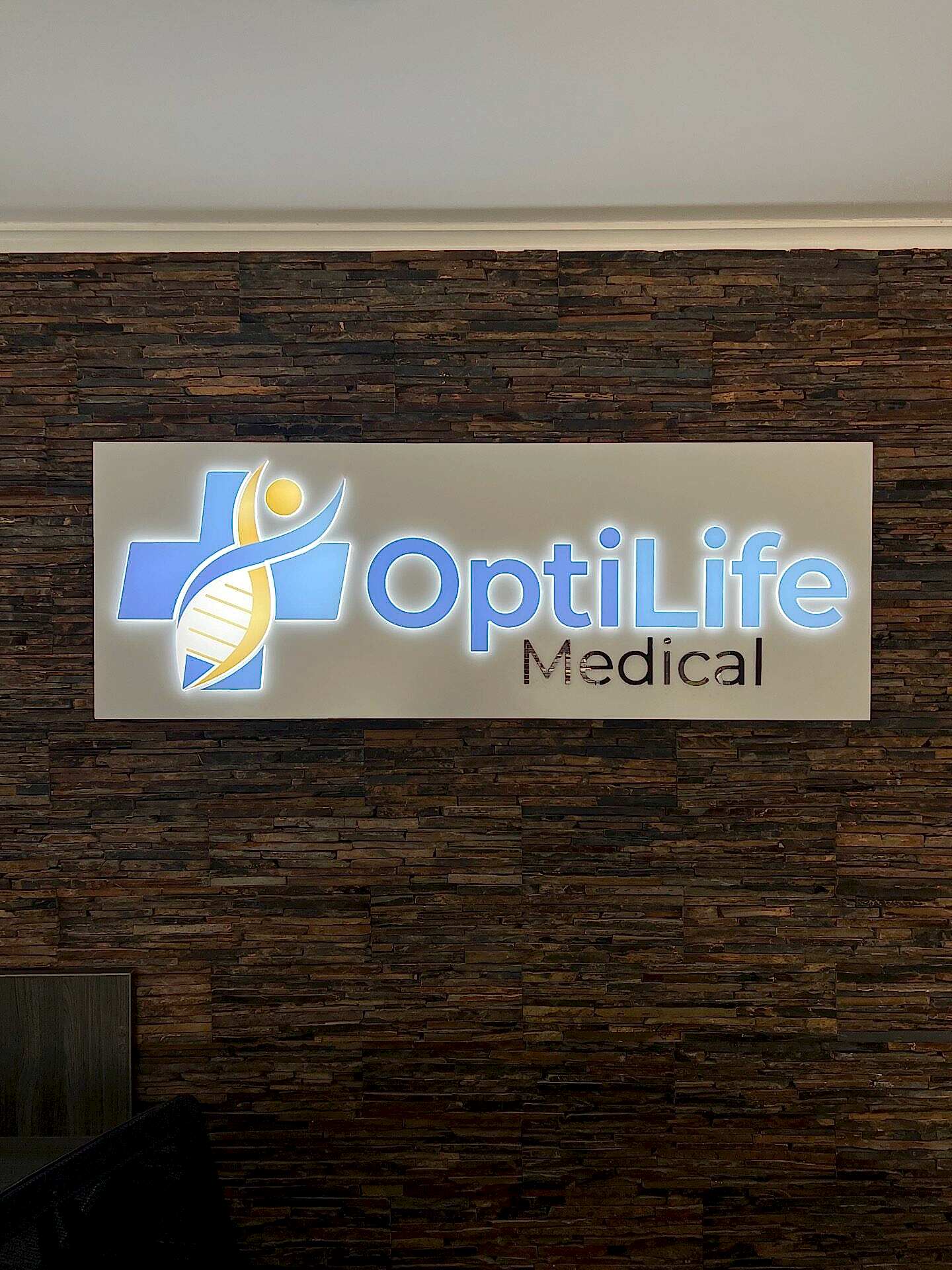 Close-up of custom LED lobby sign with translucent vinyl graphics, installed at OptiLife Medical in Roswell, Georgia.