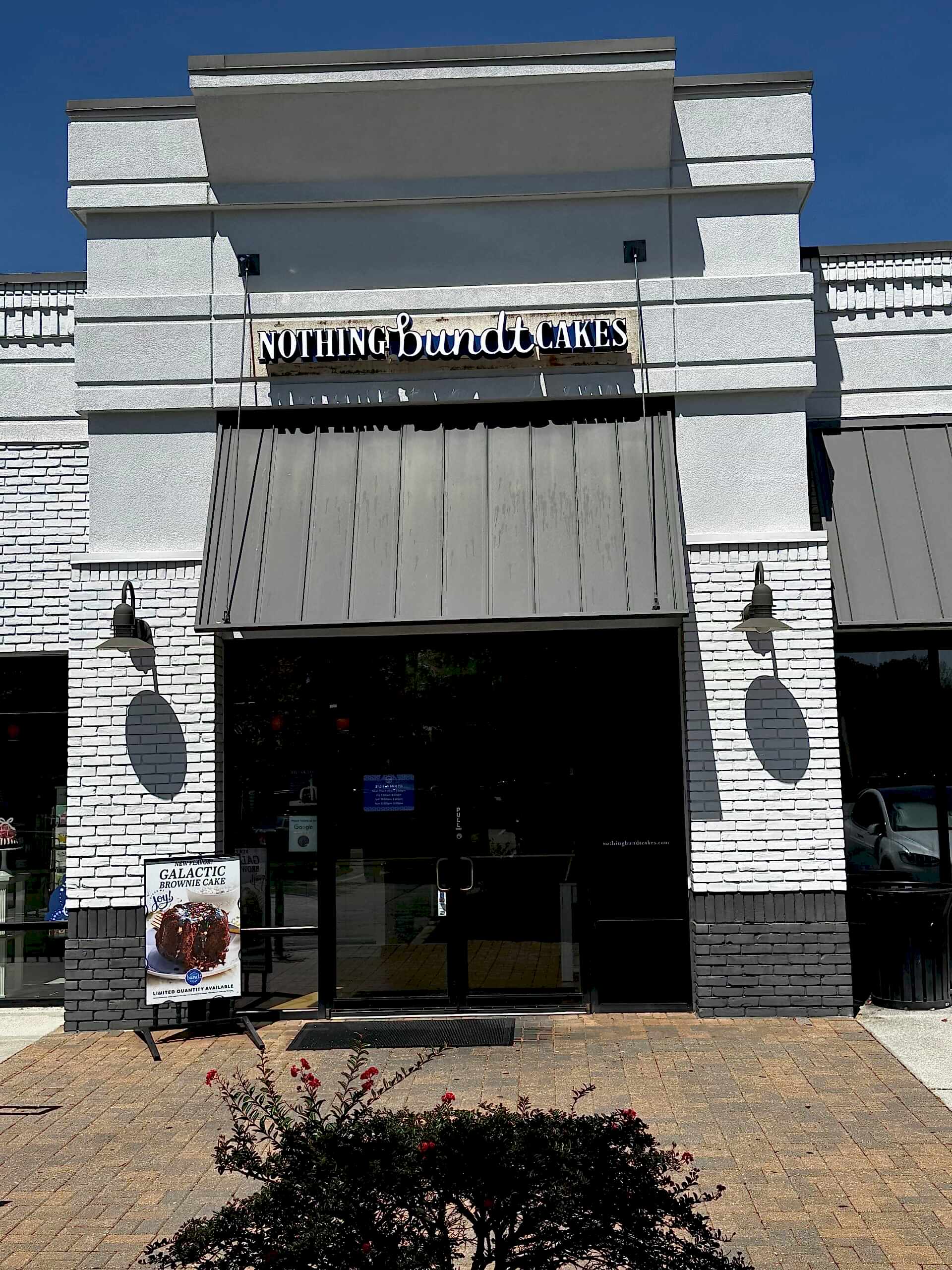 Updated Nothing Bundt Cakes storefront in Sandy Springs, GA, featuring the brand’s refreshed blue and white channel letter building sign above the entrance.