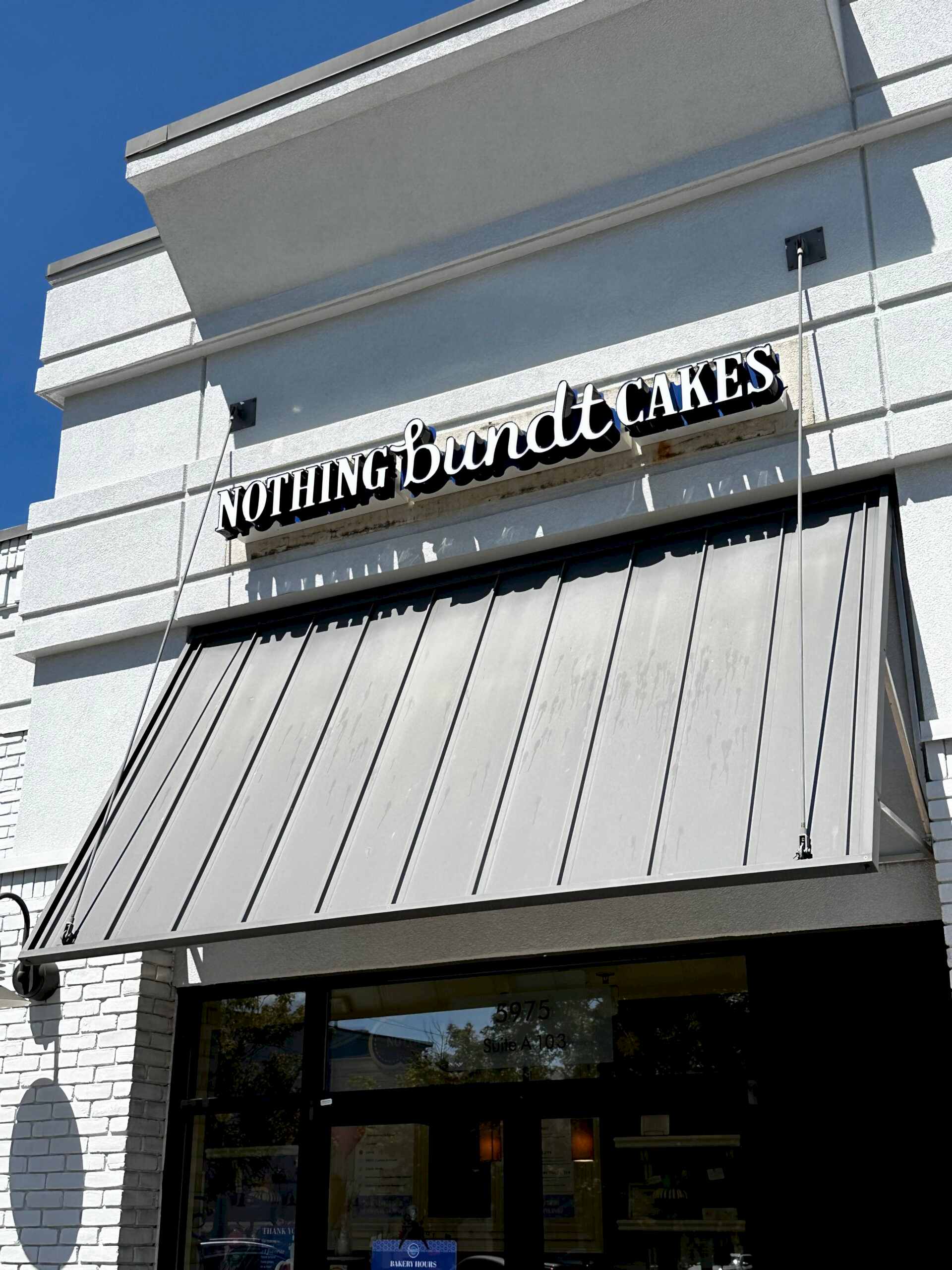 Updated Nothing Bundt Cakes storefront in Sandy Springs, GA, featuring the brand’s refreshed blue and white channel letter building sign above the entrance.