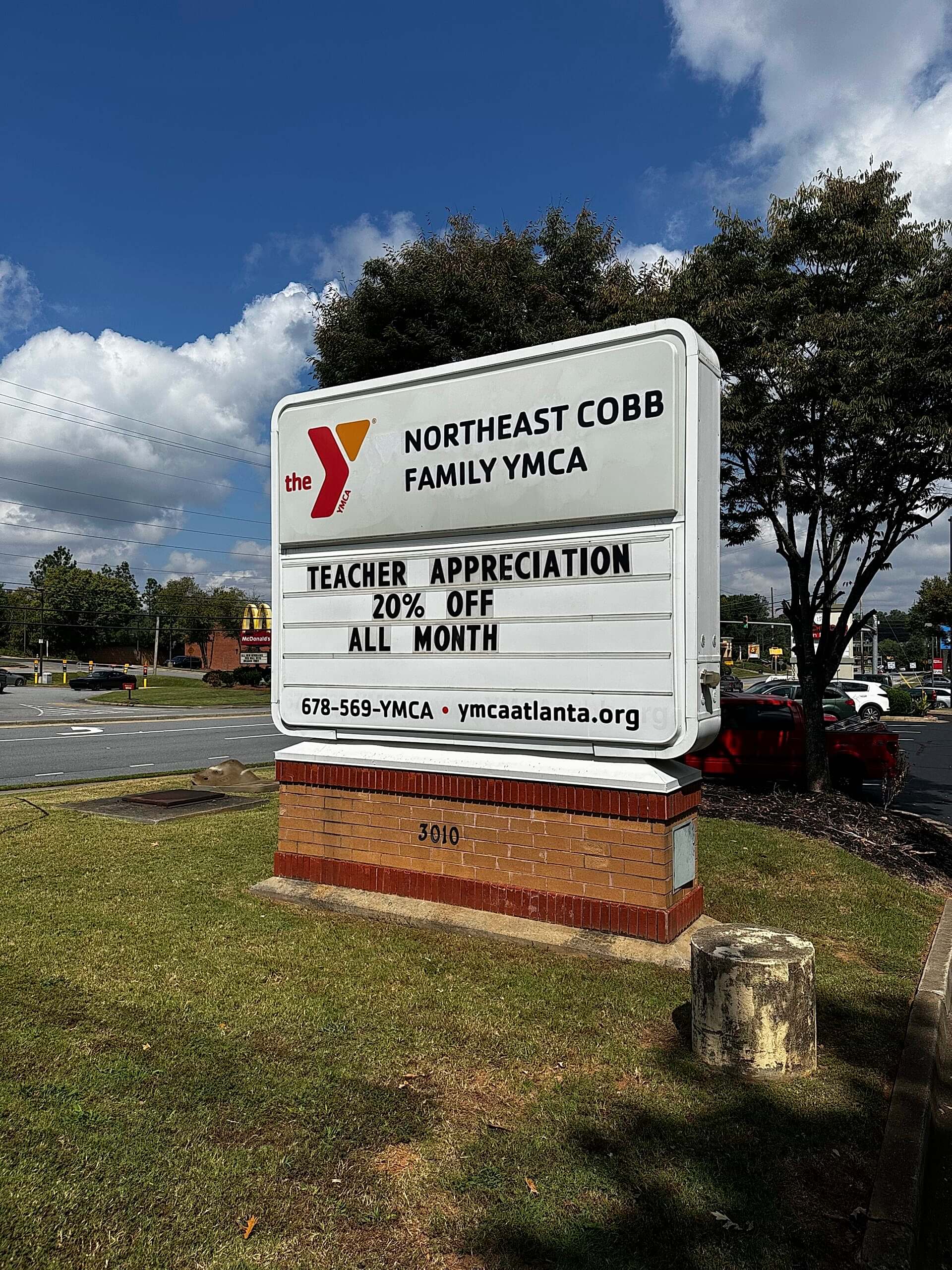 Updated Northeast Cobb Family YMCA monument sign in Marietta, Georgia, shown during the day with refreshed branding and a teacher appreciation message.